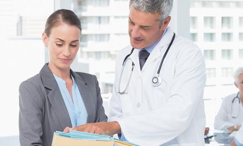 Nurse Leader Consulting with Physician About Patient Diagnosis
